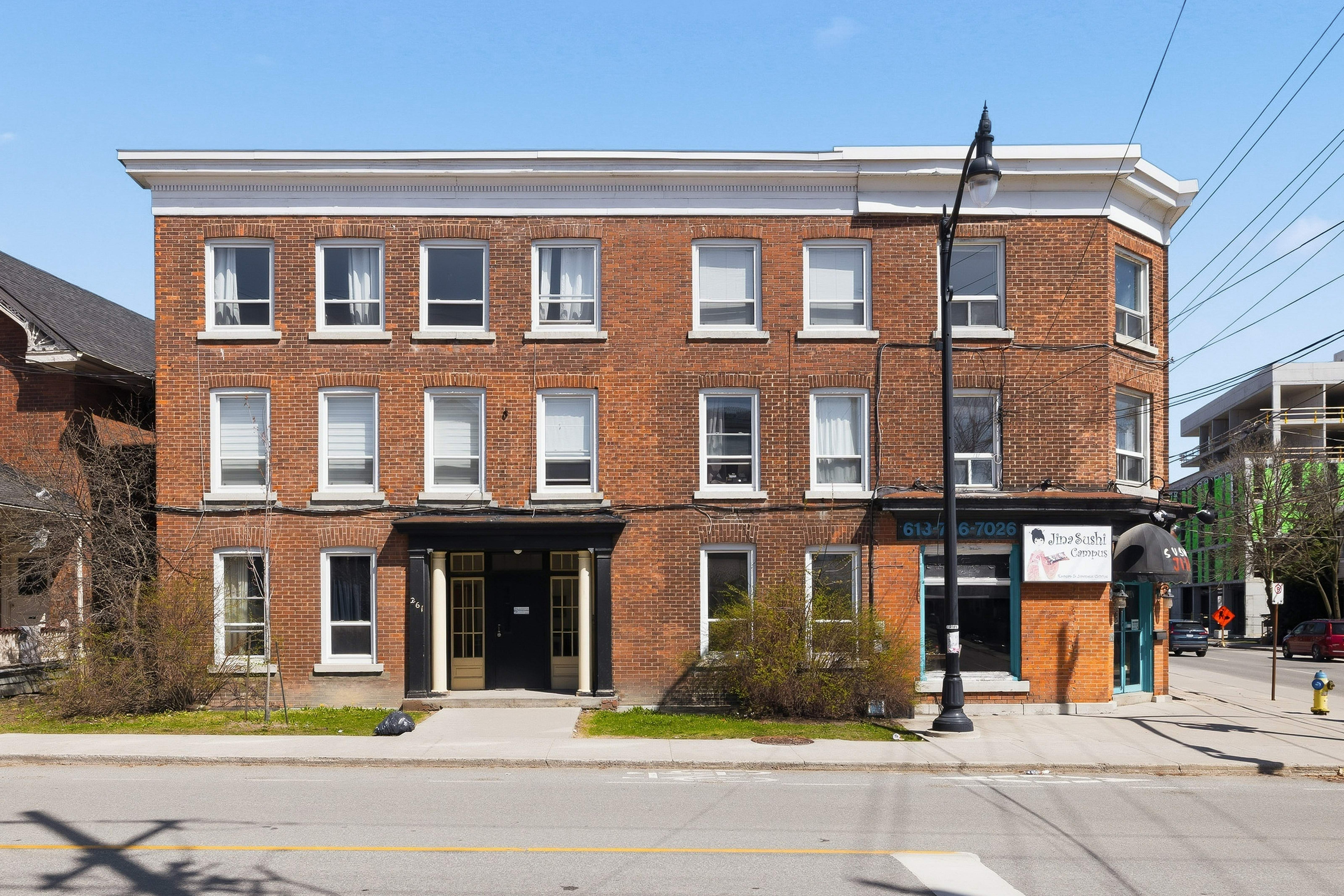 A red brick building with a black awning and a sign that says "Blackberry".